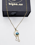 Premium quiet luxury blue sandstone moon necklace UAE.