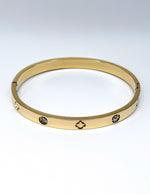 18K gold plated engraved clover and flush crystal bangle by Biya Accessoires.