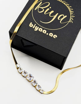 Modern luxury gold liquid chain and princess cut stone necklace UAE.