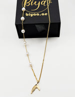 18K gold plated mermaid tail and pearl necklace by Biya Accessoires.