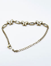 Modern luxury fine art editorial jewelry delicate gold butterfly chain bracelet gift for her.