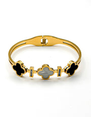 Gold bracelet with clover-shaped charms on a white background