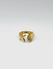 18K gold plated sculptural shell and starfish bypass ring by Biya Accessoires.