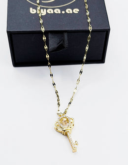 18K gold plated imperial crown key pendant with dancing stone by Biya Accessoires.