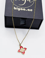 18K gold plated red quatrefoil clover pendant necklace by Biya Accessoires.