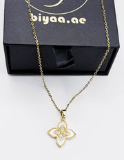 Modern luxury gold and pavé crystal quatrefoil statement necklace.