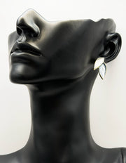Best fashion jewelry in UAE botanical leaf earrings with emerald blue enamel.