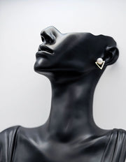 Modern open triangle stud earrings with a faux white pearl.