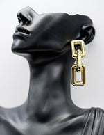 Close up of imitation jewelry uae hardware dangles featuring high-polish gold plating.