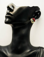 Best imitation jewellery brands in uae gold curved studs with red enamel and crystals.