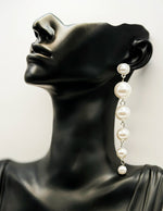 Biya Accessoires long graduated pearl drop earrings.