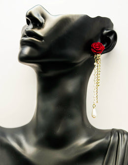 Close up of imitation jewelry uae statement drops featuring crimson rose and rhinestone chain.