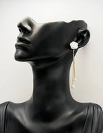 Close up of imitation jewelry uae statement studs featuring iridescent flower petals.