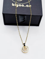 Biya Accessoires 18K gold plated baguette sunburst medallion necklace.