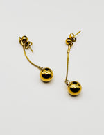 Biya Accessoires 18K gold plated minimalist sphere drop earrings with snake chain.