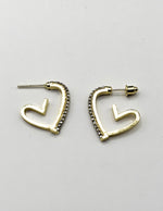 Close up of imitation jewelry uae heart hoops featuring clear pavé stones.