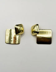 Close up of imitation jewelry uae statement studs featuring high-shine hardware.