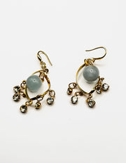 Biya Accessoires artificial jewellery online dubai gold swirl dangle earrings with opalescent bead.