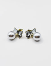 Biya Accessoires artificial jewellery online dubai pearlescent bow and pearl drop earrings.