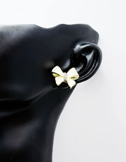 Everyday luxury fashion jewelry gold tone statement bow studs by Biya Accessoires Dubai.