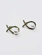 Biya Accessoires gold crisscross ribbon crystal and pearl stud earrings.