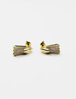 Biya Accessoires gold geometric drop earrings with white enamel inlay.