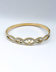 Biya Accessoires gold interlocking cut out bangle with pave stones.
