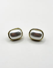 Minimalist large faux pearl earrings with a sleek gold border.