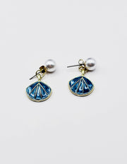 Biya Accessoires gold seashell drop earrings with blue enamel and pearl studs.