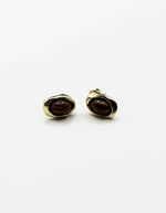 Biya Accessoires gold tiger eye stud earrings with molten frame.