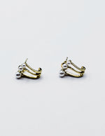 Biya Accessoires gold triple pearl claw earrings.