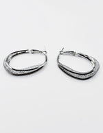 Biya Accessoires silver triple band hoop earrings with stardust texture.