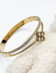 Biya Accessoires Luminous Clover 18K gold plated dual-band bangle presented in a premium charcoal-grey gift box.