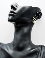 Close-up of hypoallergenic imitation jewelry featuring a pearl and pavé design.