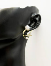 Biya Accessoires gold floral pearl ear jacket earrings.