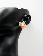 Best fashion jewelry in UAE bow-shaped crystal earrings in rose-gold pearl.