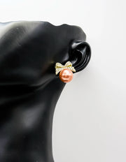 Best fashion jewelry in UAE bow-shaped crystal earrings in rose-gold pearl.