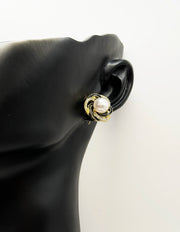 Biya Accessoires gold camellia stud earrings with black enamel and pearls.