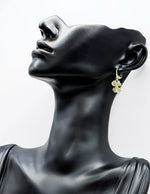 Biya Accessoires gold four leaf clover drop earrings with crystals.