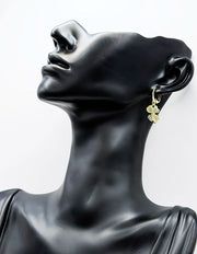 Biya Accessoires gold four leaf clover drop earrings with crystals.