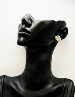 Close-up of premium hypoallergenic imitation jewelry featuring an interlocking gold design.