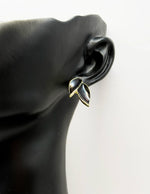 Best fashion jewelry in UAE botanical leaf earrings with emerald black enamel.
