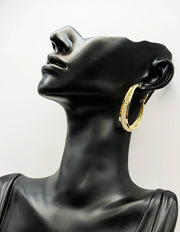 Close-up of premium hypoallergenic imitation jewelry frosted gold hoop earrings.