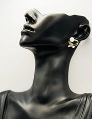 Close up of elegant imitation jewelry uae featuring a pavé crystal butterfly and faux pearls.