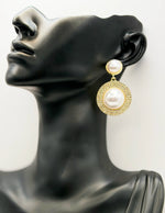 Close up of elegant imitation jewelry uae featuring oversized faux pearls and a crystal pavé setting.