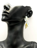 Close up of imitation jewelry uae statement crawlers with blue resin and pavé.