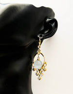 Close up of imitation jewelry uae statement drops featuring twisted frame and crystal fringe.