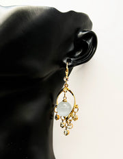Close up of imitation jewelry uae statement drops featuring twisted frame and crystal fringe.
