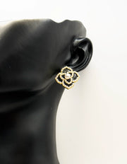 Close up of imitation jewelry uae statement studs featuring seed pearl borders.