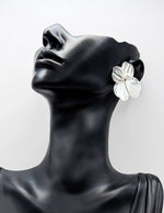Close up of premium hypoallergenic imitation jewelry featuring a large wire petal design.
